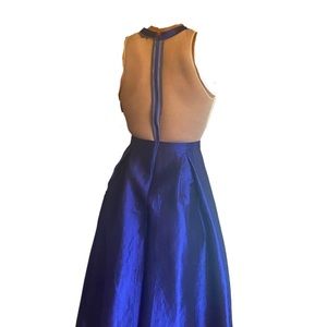Mesh back and waistline blue gown with bronze and silver rhinestoned halter top.